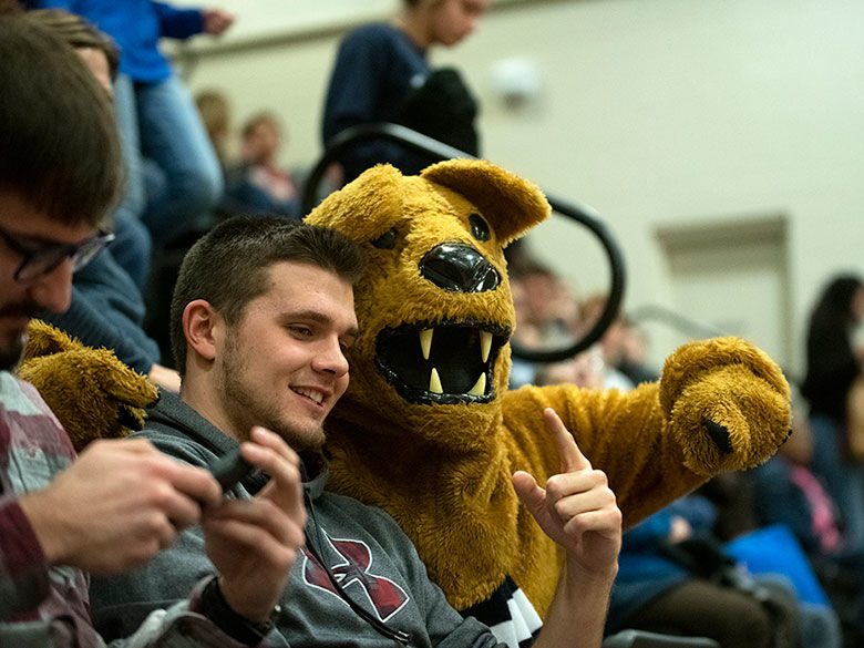 Student with the Lion at the game.
